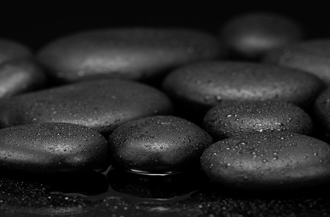 Close-up of dark stones with a blurred background