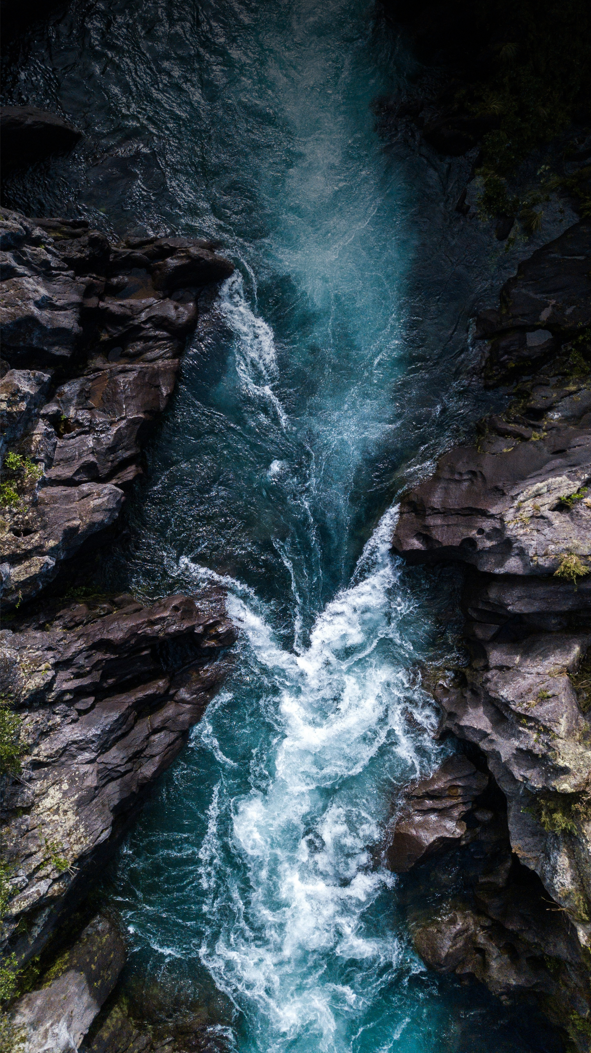 Turquoise water flowing between rocky cliffs